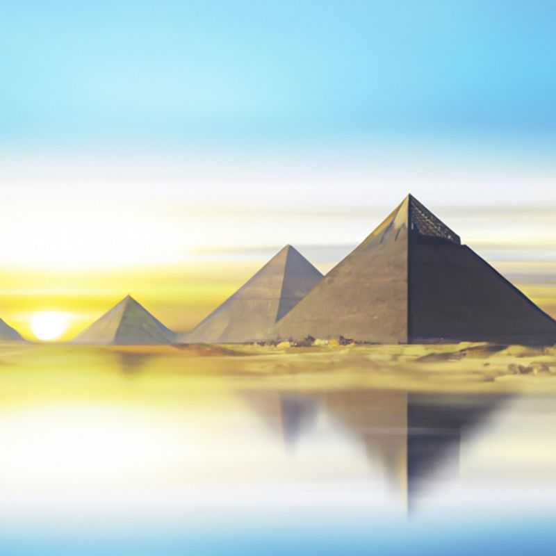Four intrepid travelers stand in awe before the majestic Pyramids of Giza, Egypt, bathed in the warm glow of the autumn sun, embarking on a week-long exploration of this ancient land's wonders.