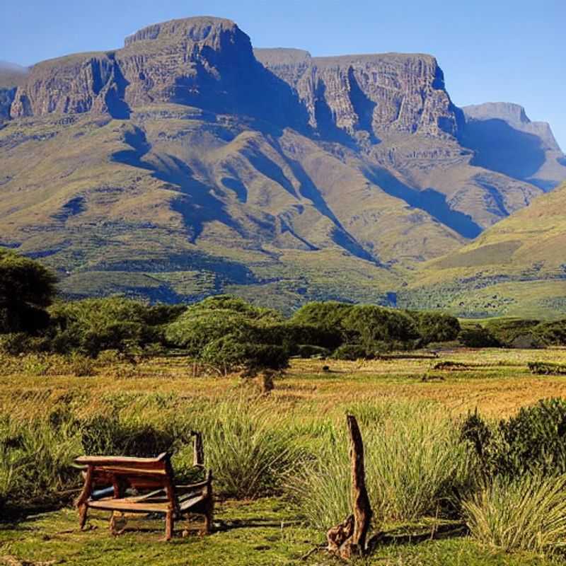 Majestic Drakensberg Mountains bask in the South African summer sun, beckoning adventurers to explore its lush valleys and towering peaks - discover why it's the perfect summer holiday destination.