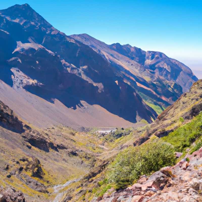 A lone adventurer stands atop Mount Toubkal, the highest peak in North Africa, during their 5-day trek between winter and spring, capturing the breathtaking panorama of Morocco's Atlas Mountains.
