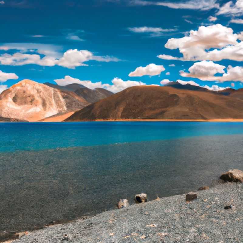 A couple embarks on a whirlwind 24-hour summer adventure in Ladakh, India, surrounded by the breathtaking vista of snow-capped mountains and azure skies, capturing the essence of this enchanting land.